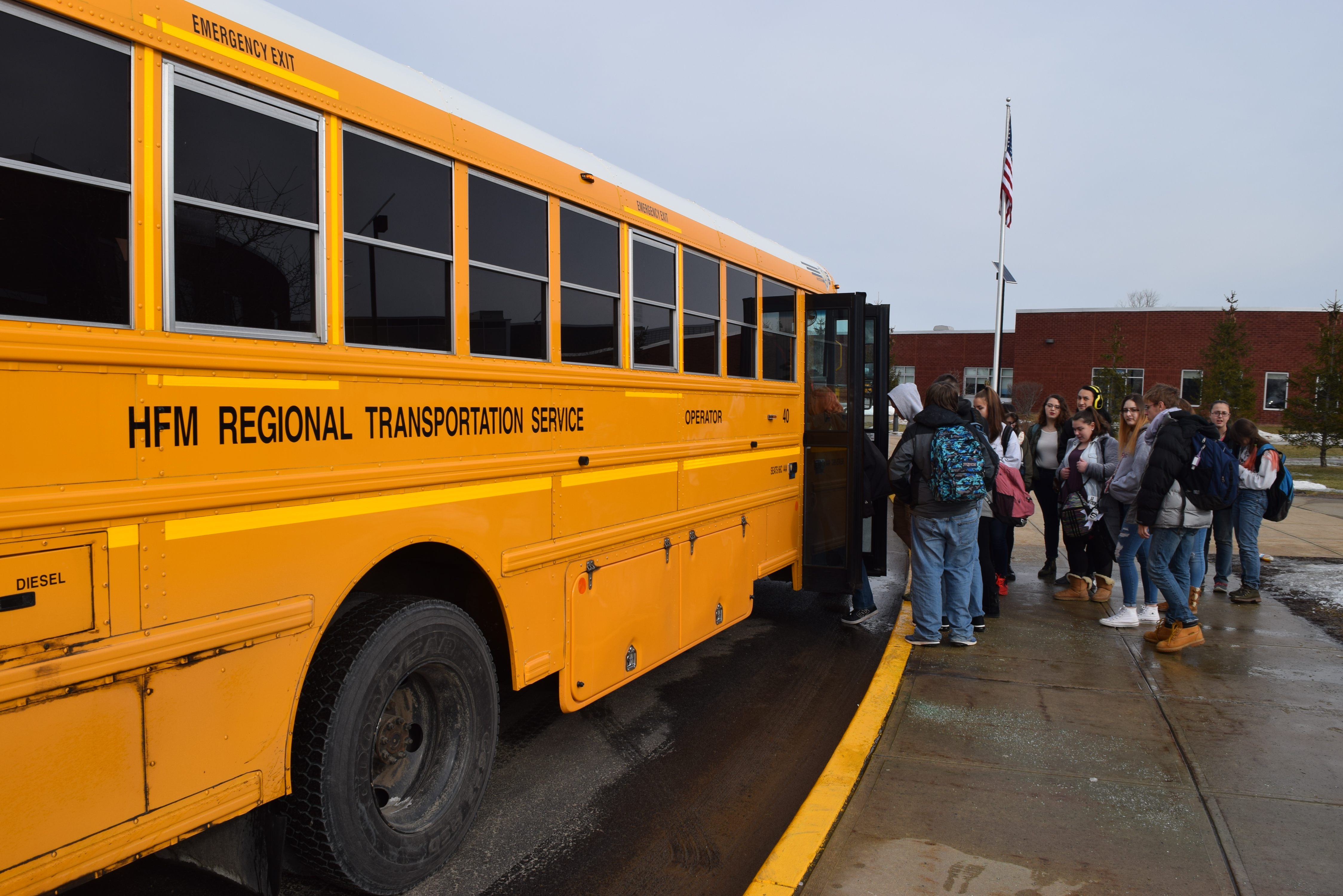 students getting onto a school bus