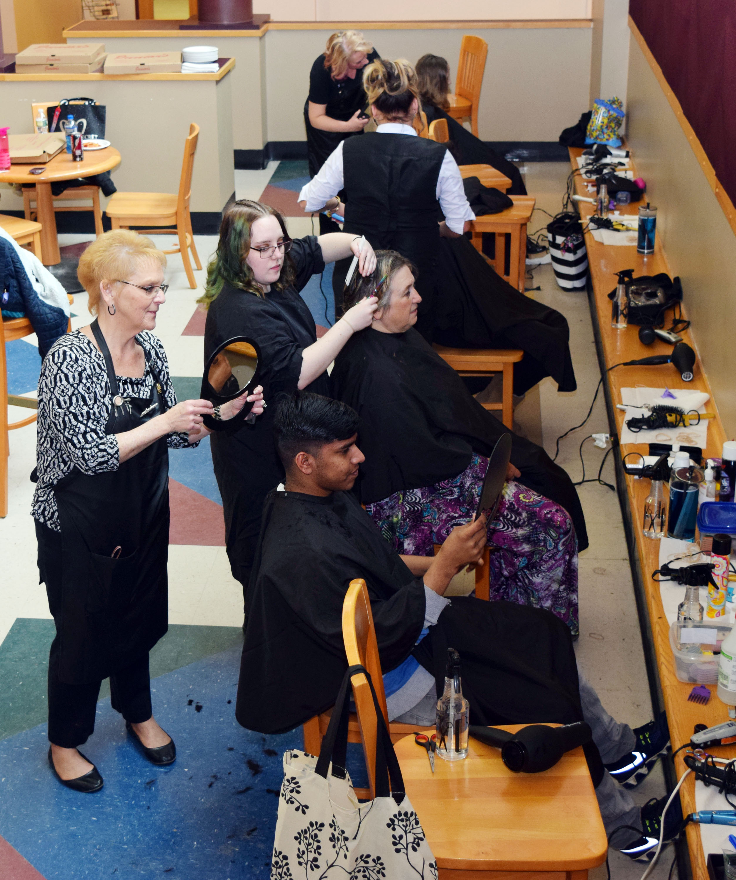 Student costemologists cuts a students' hair.