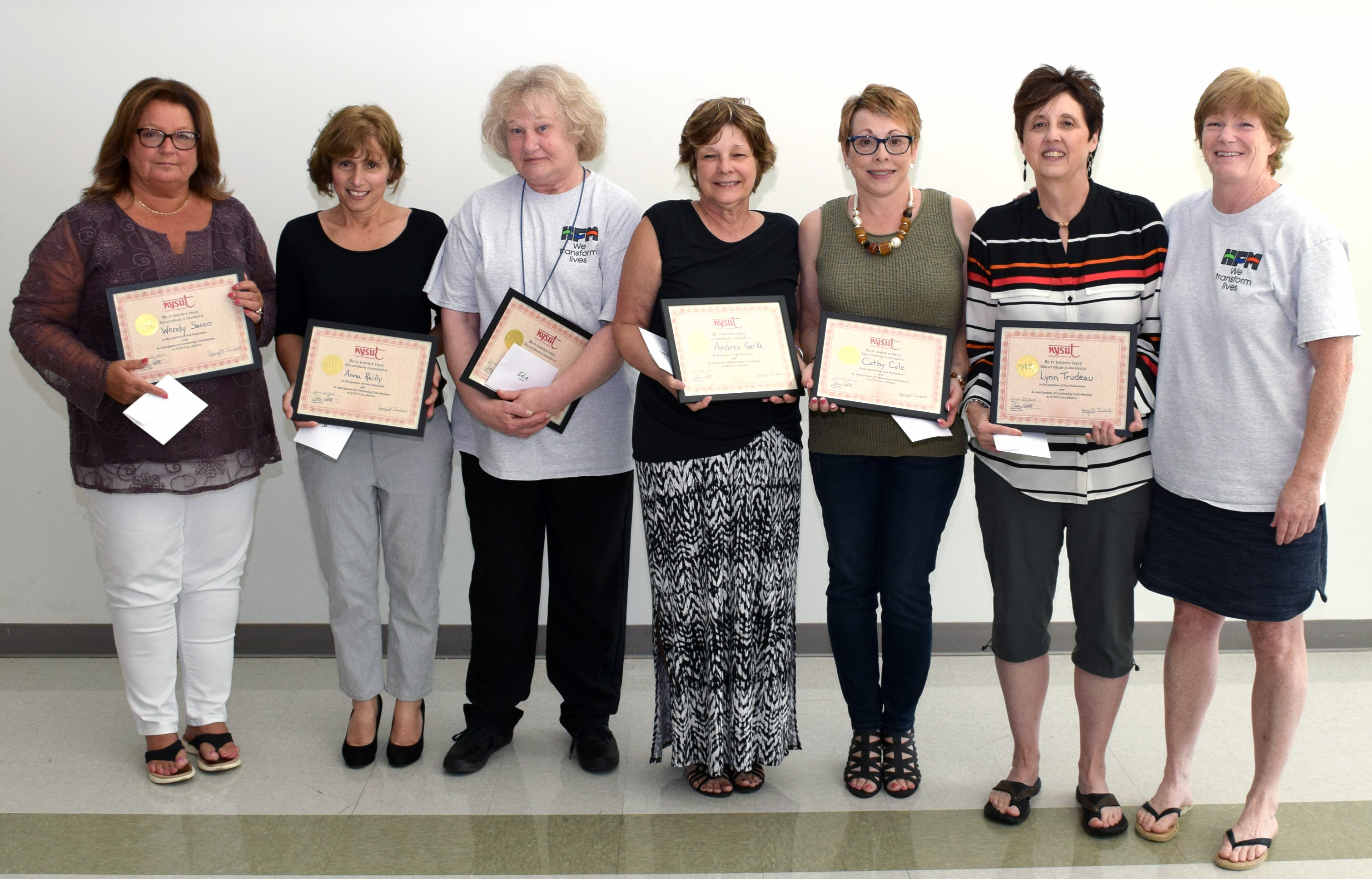 Six women stand with their union president smiling for a photo.
