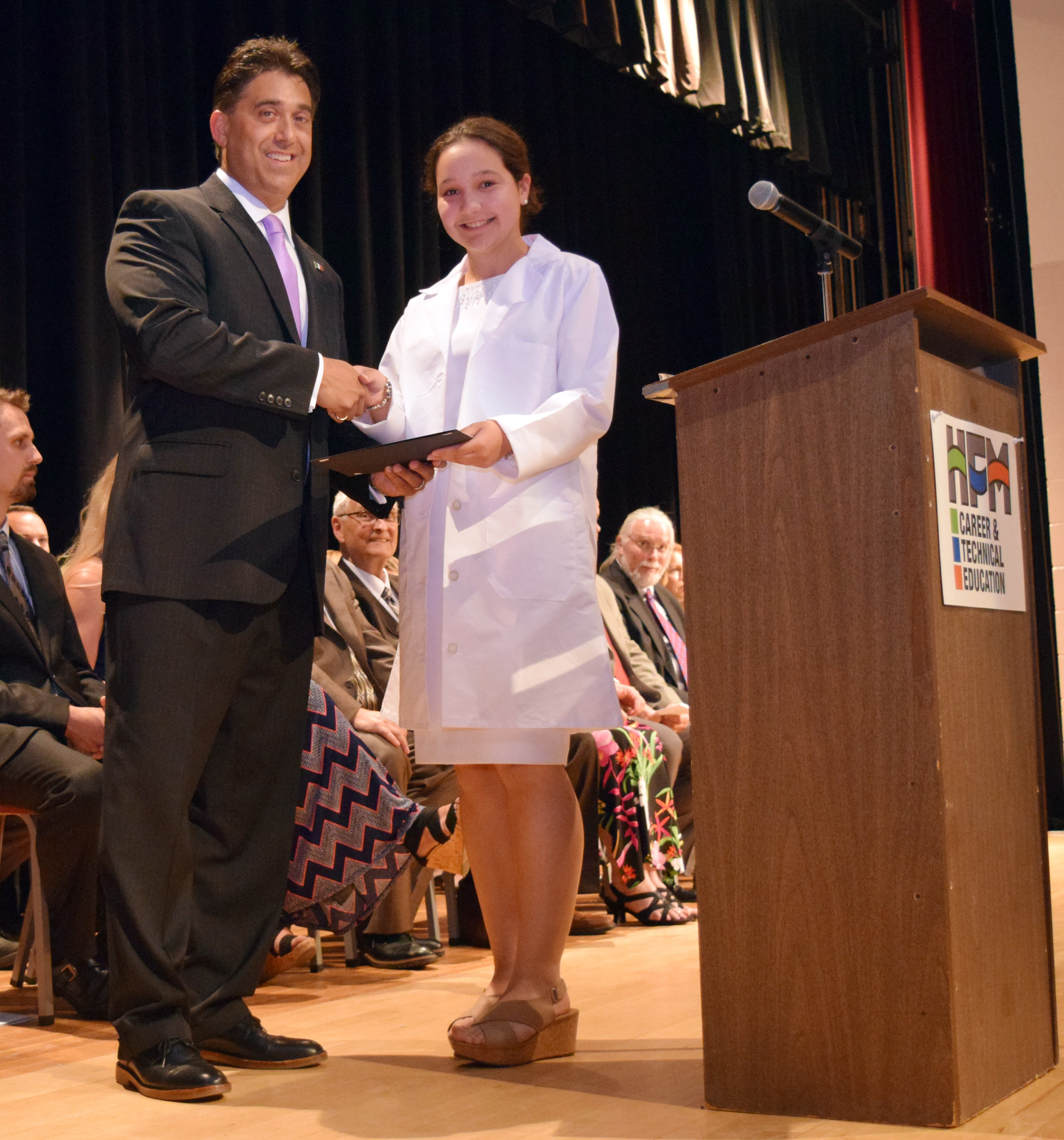 Mr. DeTraglia shakes hands with Molly Monge.