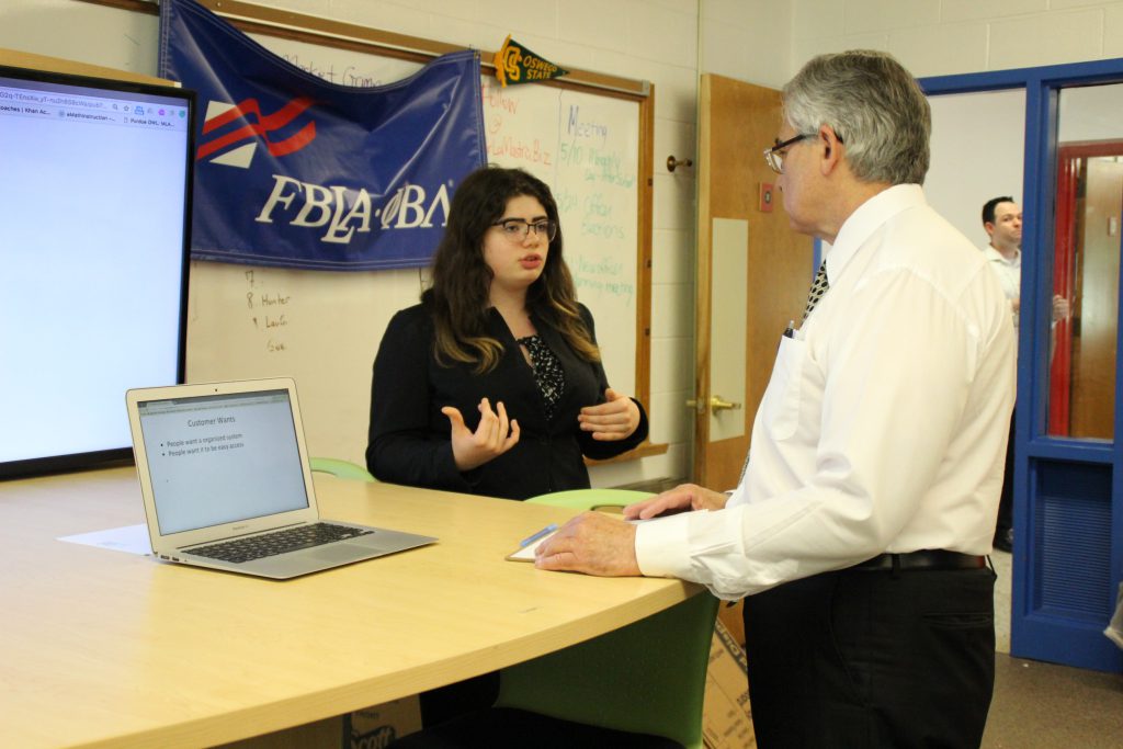 A student speaks to a business professional about her business concept