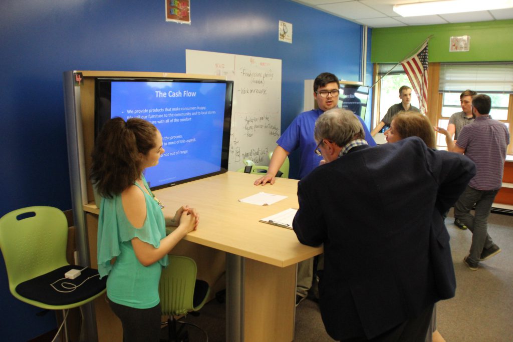 A student speaks to a business professional about his business concept