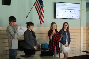 From left, Adam Feagles, Ashlee Cotton, Kristen Quist and Madison Blood present their plans for an orchard on the Ag PTECH school grounds to local orchard owners for feedback.