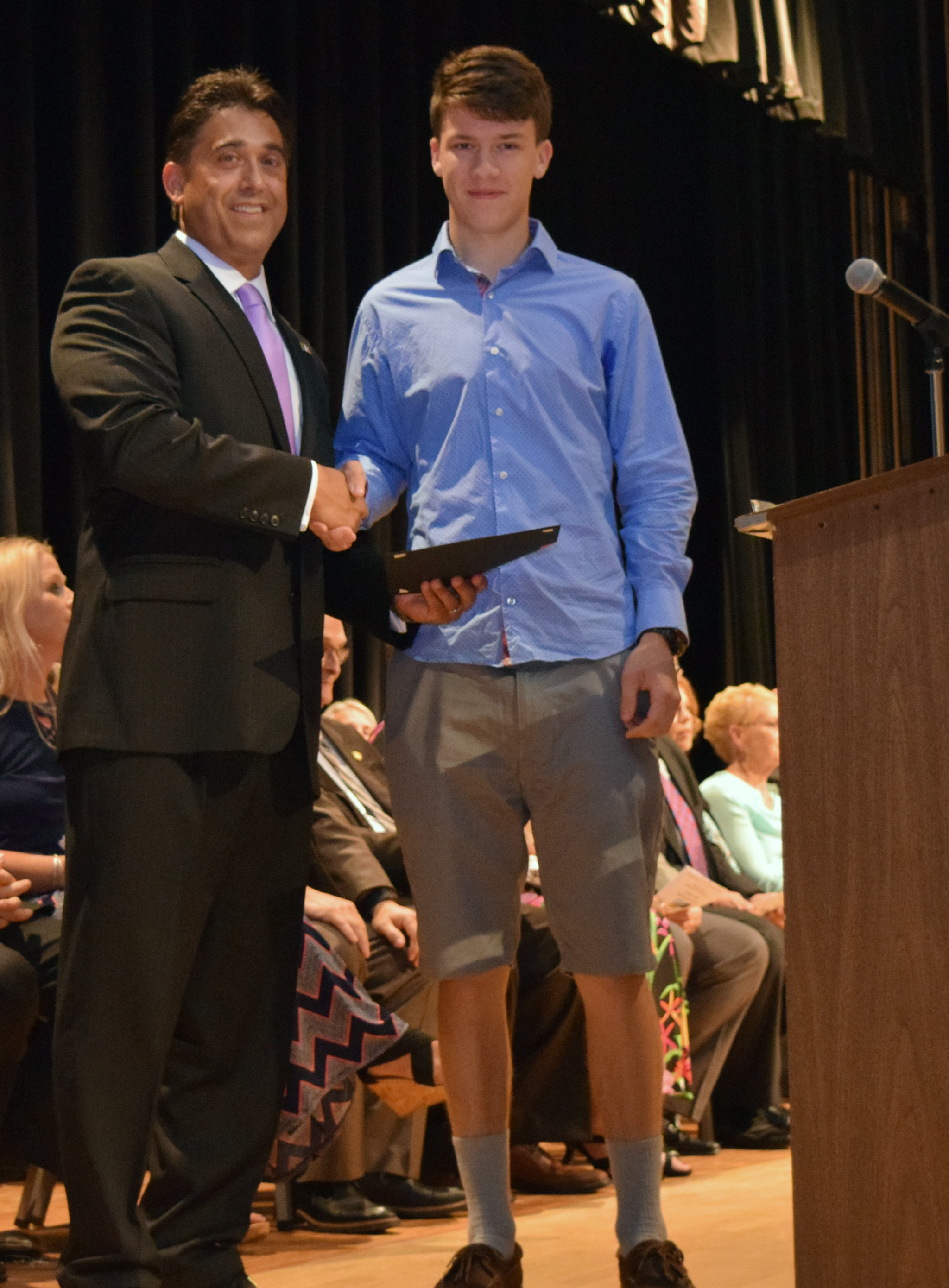 William Dickson shakes hands with Mr. DeTraglia.