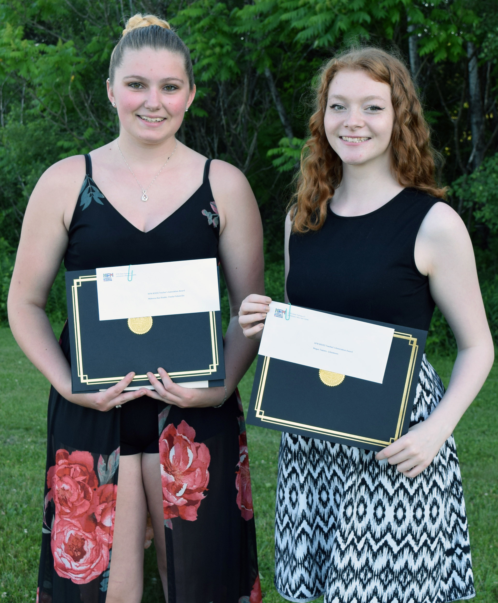 Bladek and Tesiero hold their certificates posing for a picure.