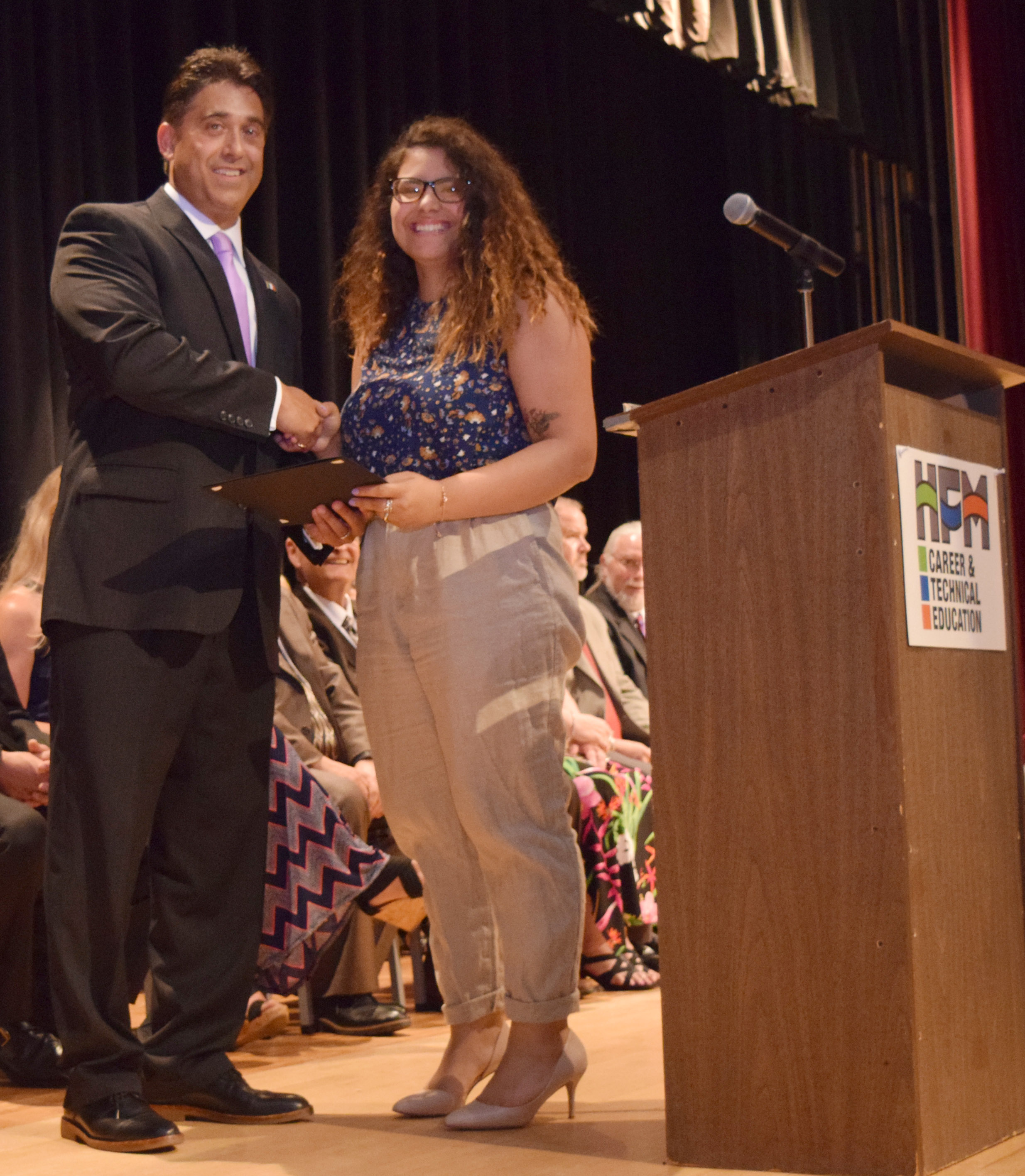 Mr. DeTraglia shakes hands with Mercado.