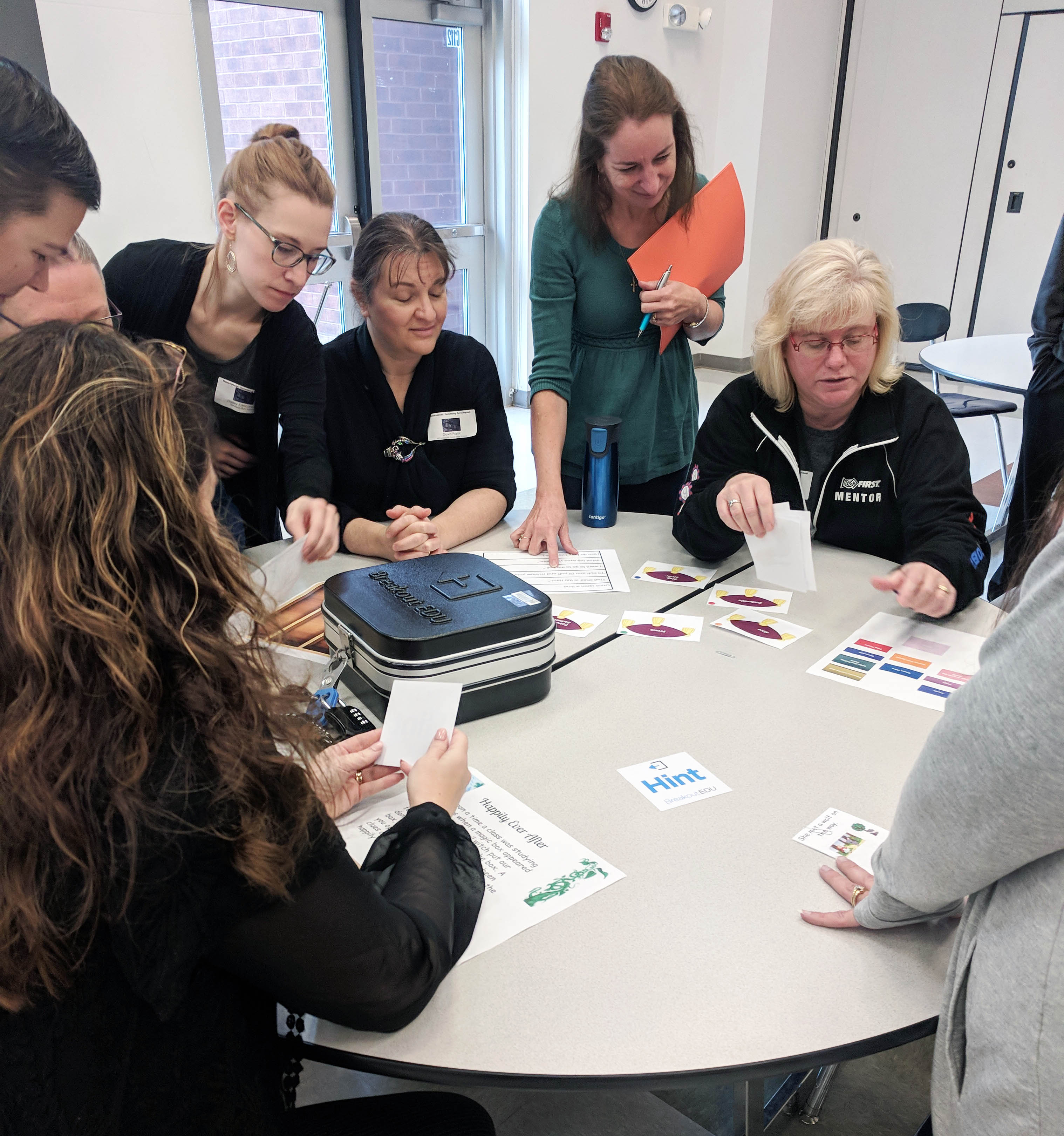 librarians play a table top game with each other.