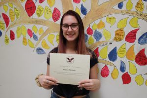 Gianna Merendo posing with her award