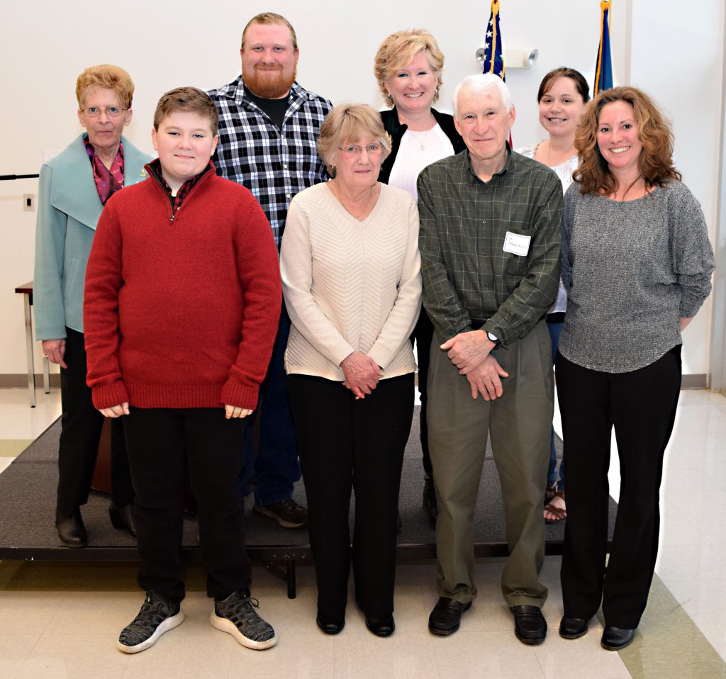 Eight people pose for a group shot