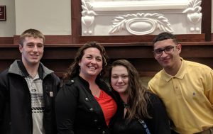 Mrs. Drake poses with students who presented at the meeting