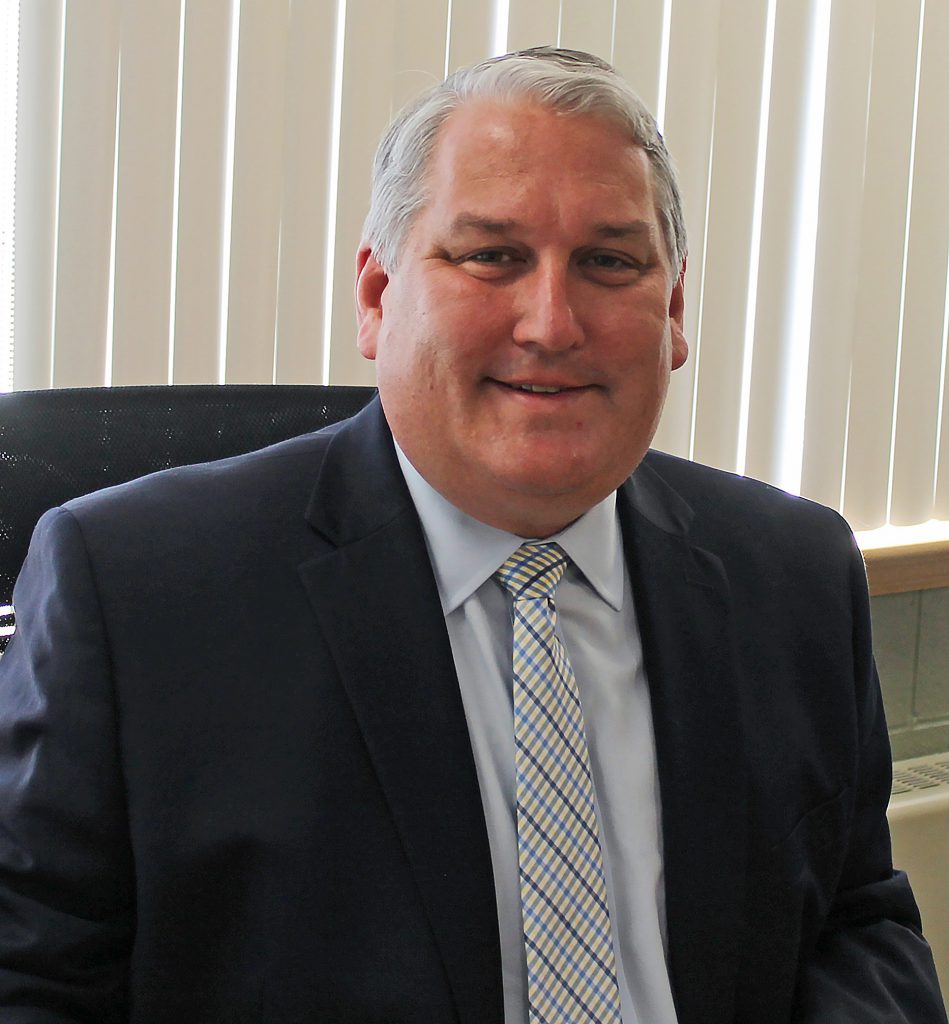 Dave Ziskin sits at a desk.