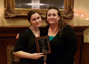 Nadia Payan holds her award and poses with teacher Jennifer Drake