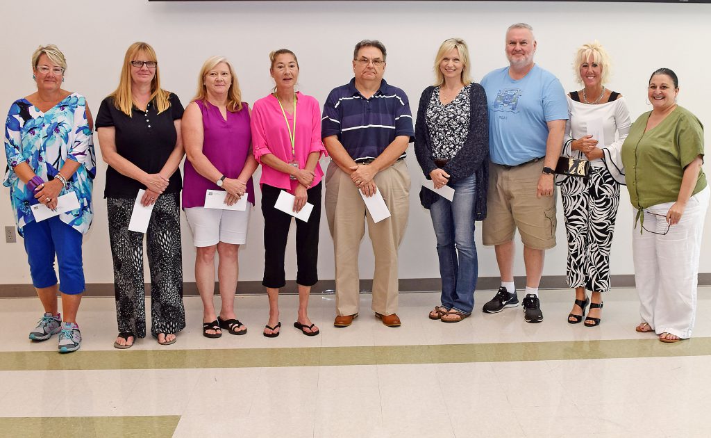 nine employees pose for a photo