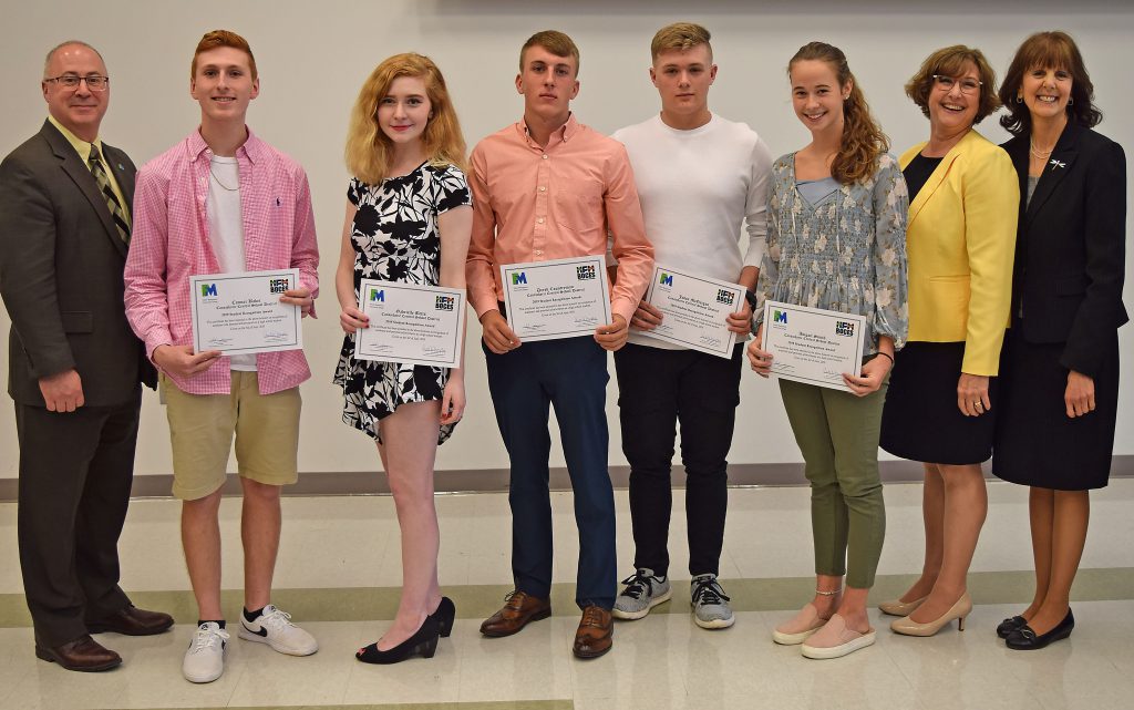 Students hold their certificates and stand with college, BOCES and school administrators to pose for a photo