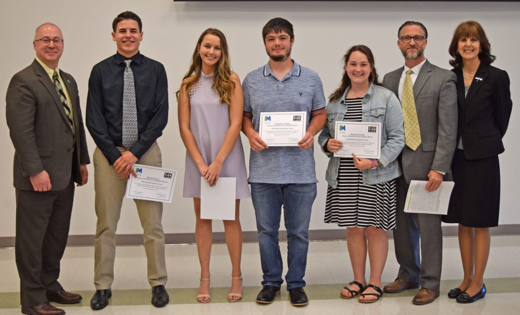 Students hold their certificates and stand with college, BOCES and school administrators to pose for a photo