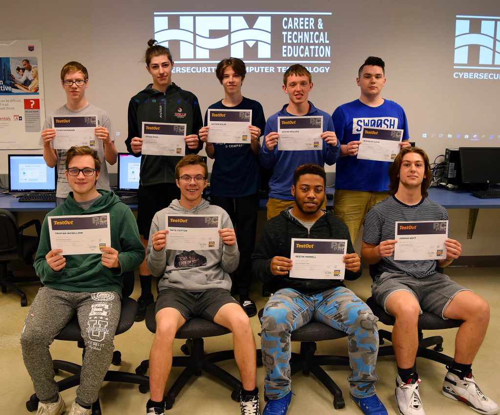 Nine Cybersecurity students pose with their certificates