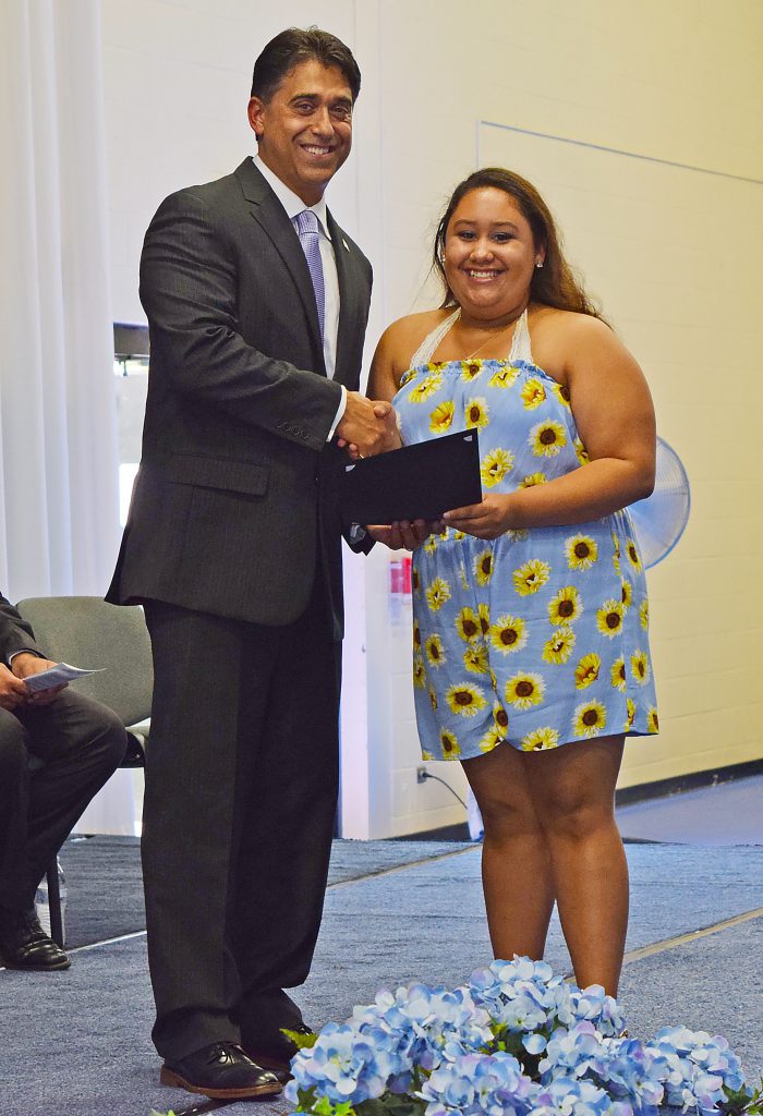 DeTraglia and a student shake hands