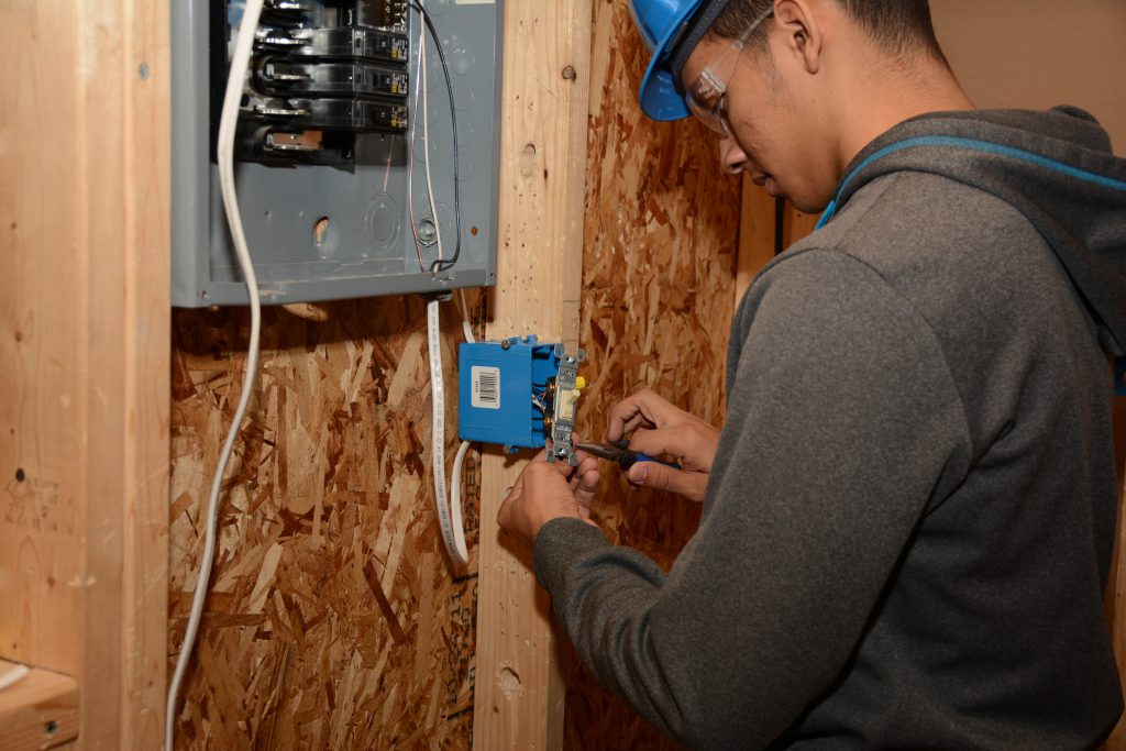 A student wires and electrical outlet