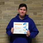 Ethan Blood standing holding his award