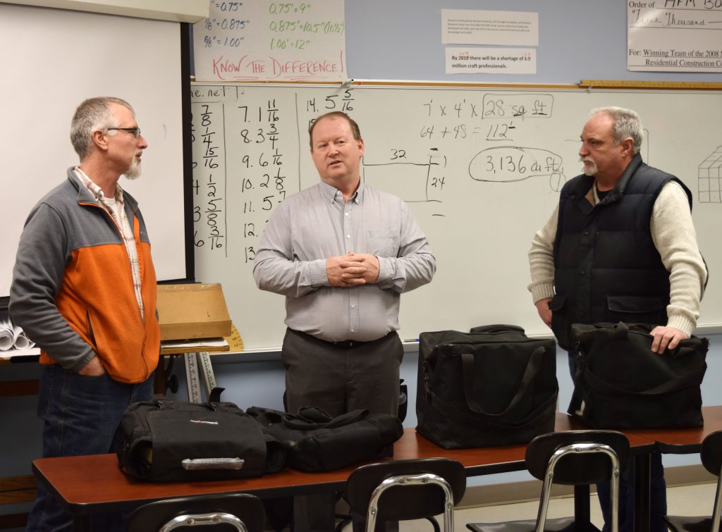 From left, HFM Construction Technology Instructor Steve Derwin, Scott Dewsbury, the local territory sales manager for Reeb Millwork and Donald Wicksell, the president and CEO of Kingsboro Lumber in Gloversville.