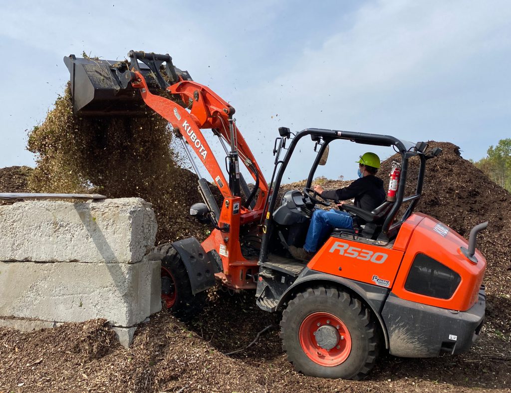 A students operates a loader