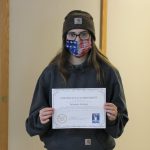 Female student holding certificate