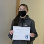 Female student holding certificate