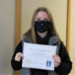 Female student holding certificate