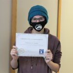 Female student holding certificate