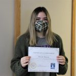 Female student holding certificate