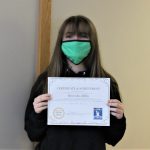 Female student holding certificate