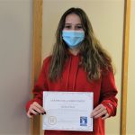 Female student holding certificate