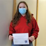 Female student holding certificate