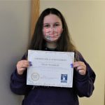 Female student holding certificate