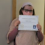 Female student holding certificate