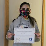 Female student holding certificate