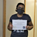 Female student holding certificate