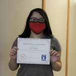 Female student holding certificate