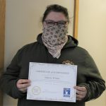 Female student holding certificate