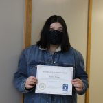 Female student holding certificate