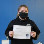 Female student holding certificate