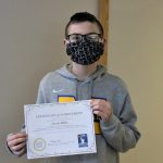 Male student holding certificate