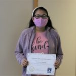 Female student holding certificate