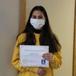 Female student holding certificate