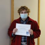 Female student holding certificate