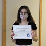 Female student holding certificate