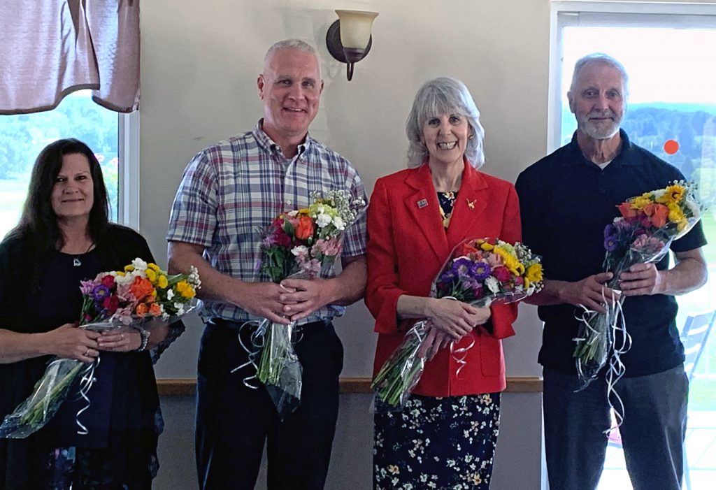 four retirees pose for a photo