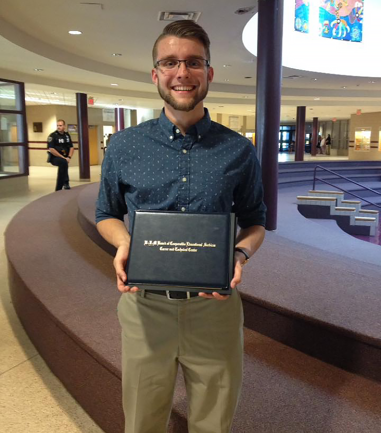 Zachary Ropeter stands posing with this CTC certificate.