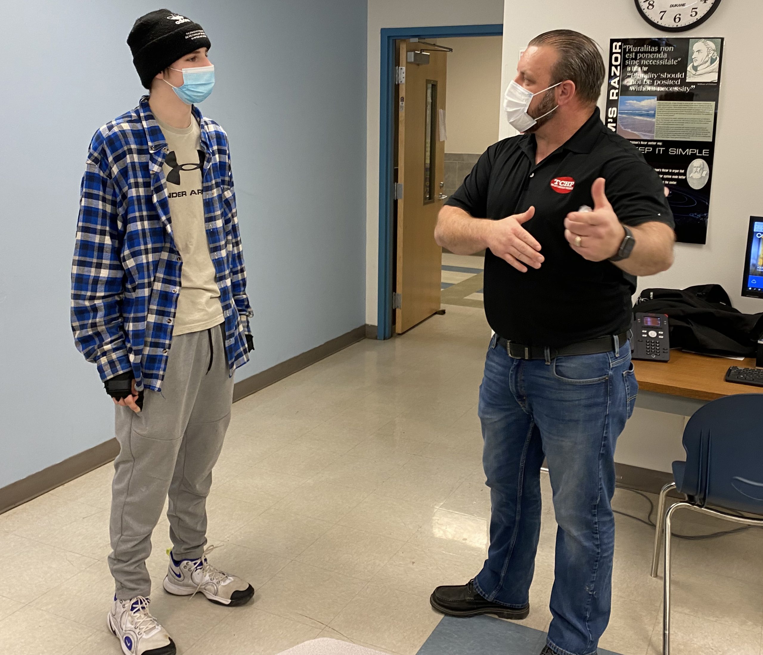 Slaughter speaks with a student in a classroom