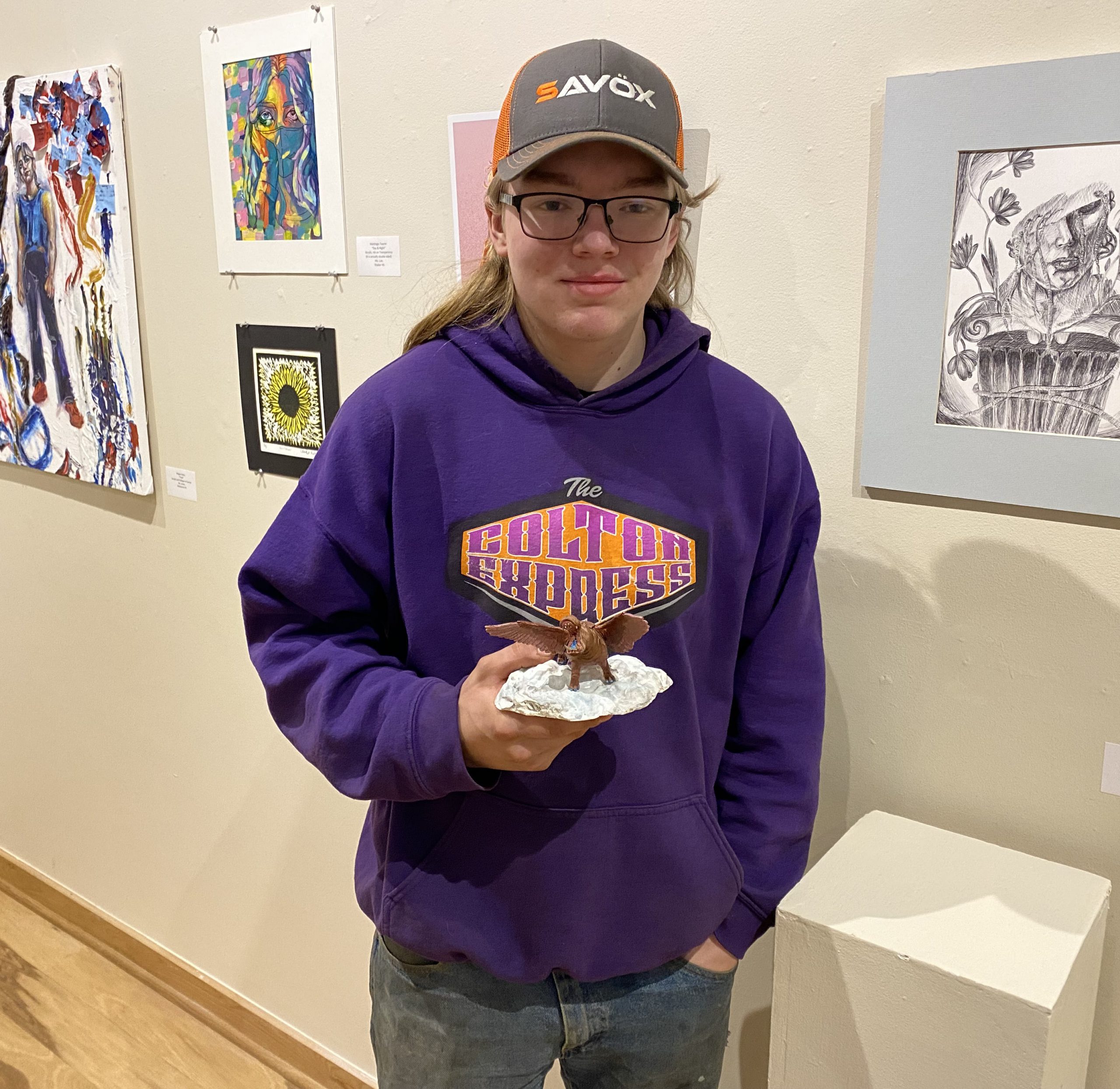 William Vicciarelli holds up his winged hippo artwork